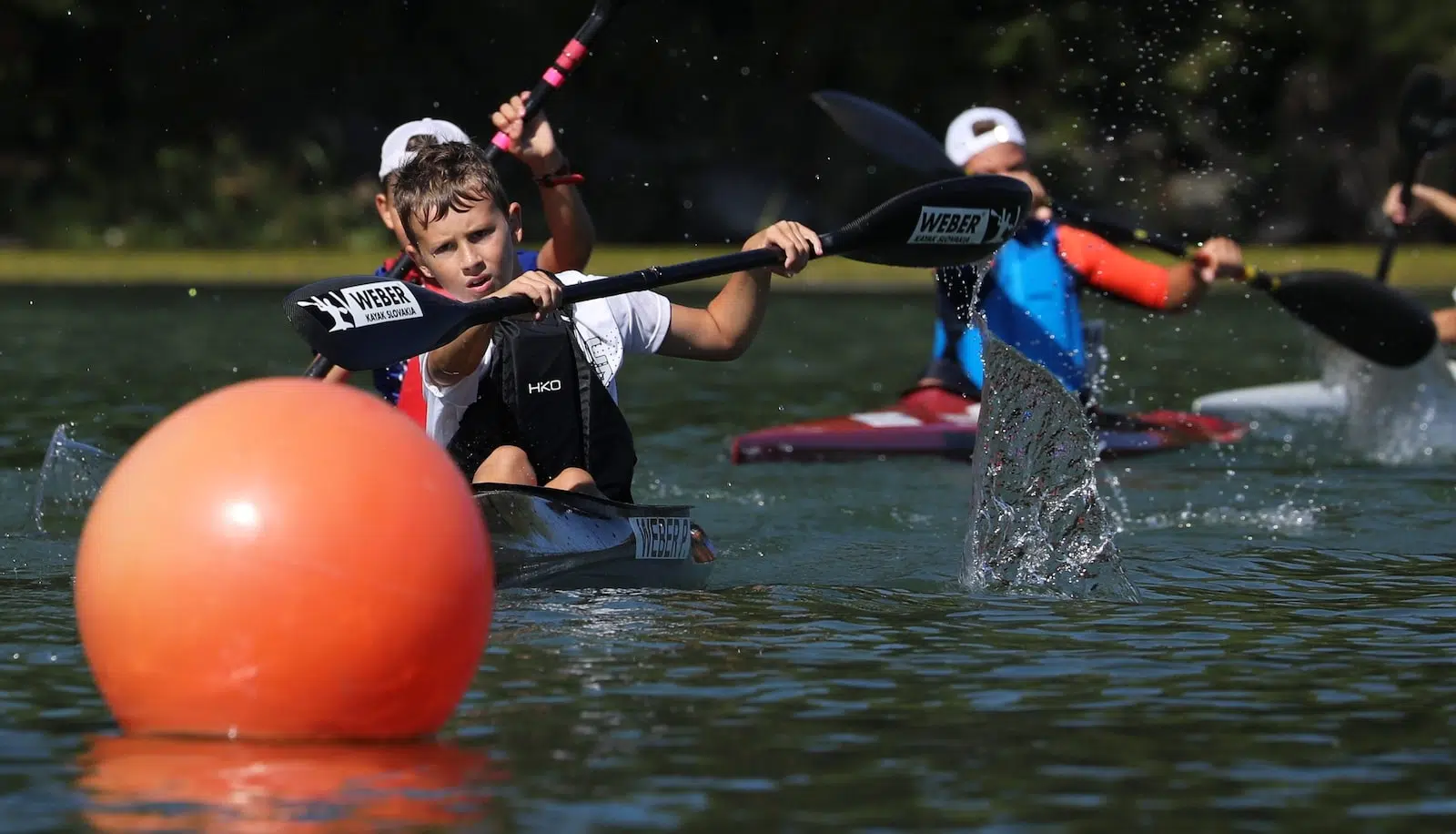 man in black and white jacket riding on kayak